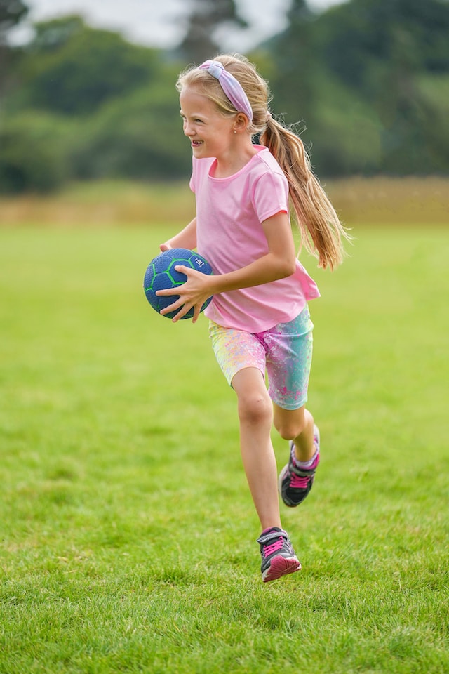 Girl running with ball