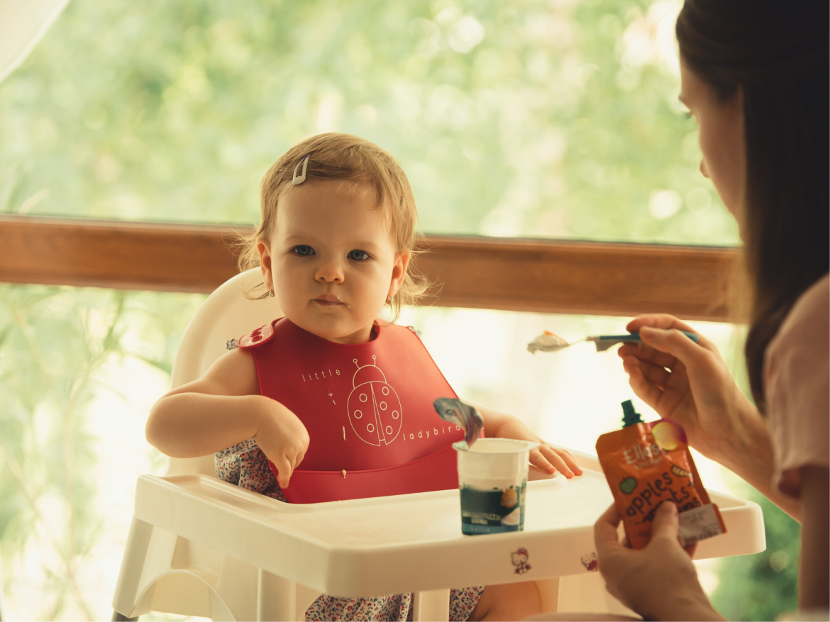 Infant eating yogurt