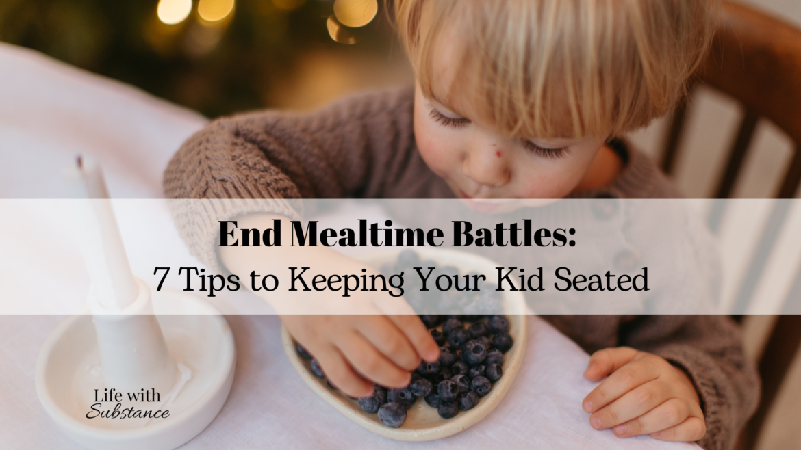 Kid seated at the table eating blueberries